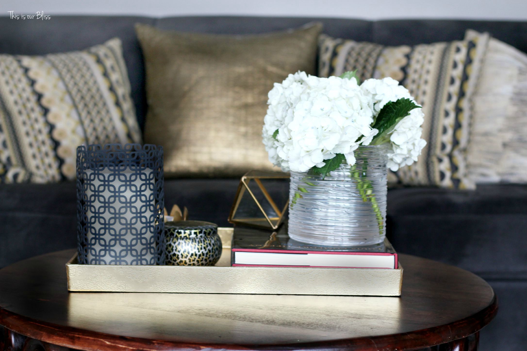 how to style a coffee table - coffee table styling - formal living room couch - gallery wall - elements of a well-styled coffee table 1 - gold detail - back to basics - This is our bliss