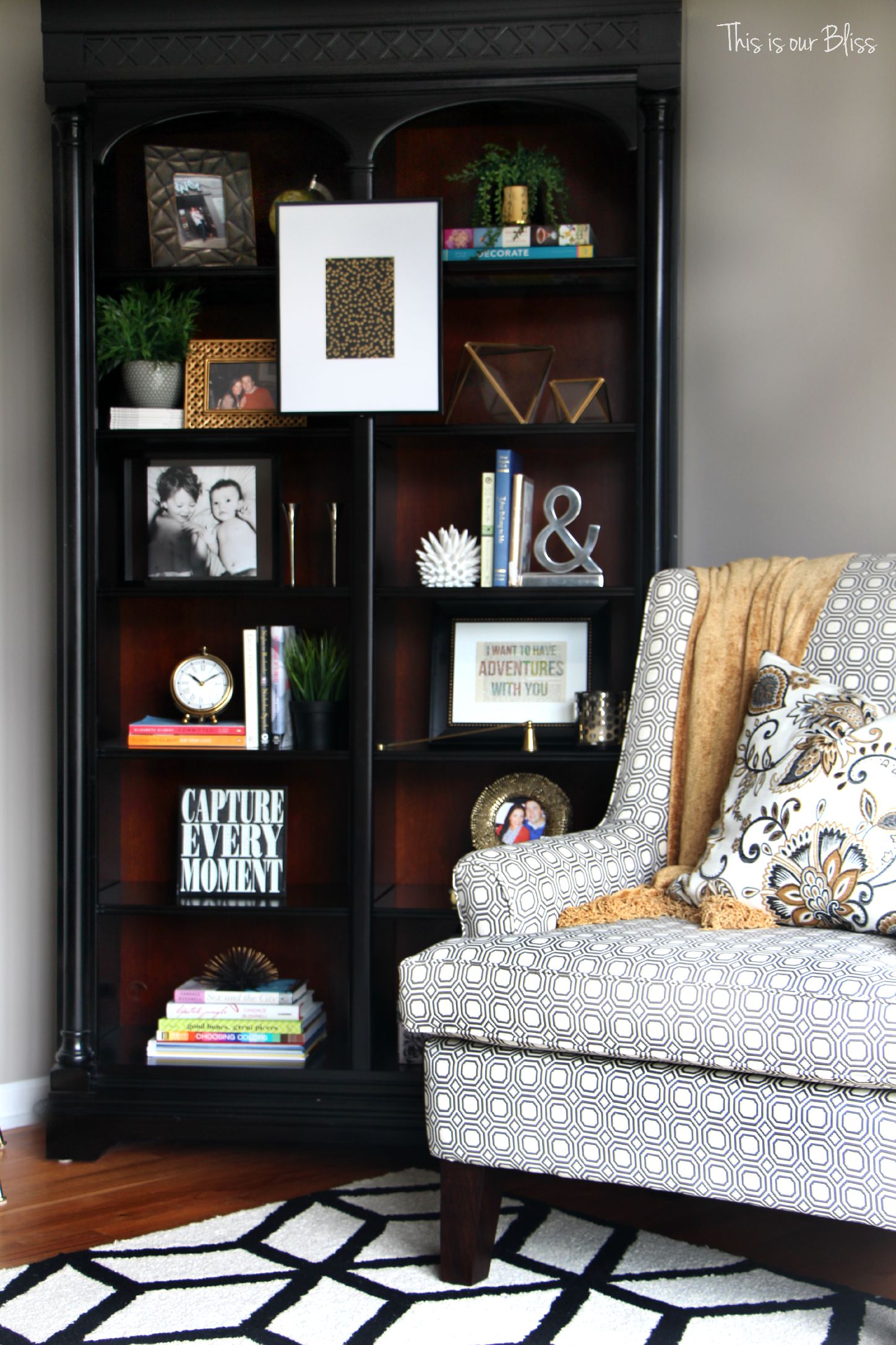 how to update an old bookcase with command hooks - 30 second makeover - formal living room bookcase - hanging art on a bookcase - living room chair - bookcase after - This is our bliss