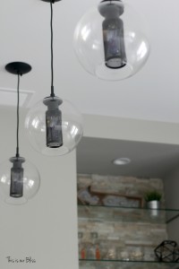 Basement bar modern industrial pendant lights stacked stone feature wall neutral decor basement project progress This is our Bliss