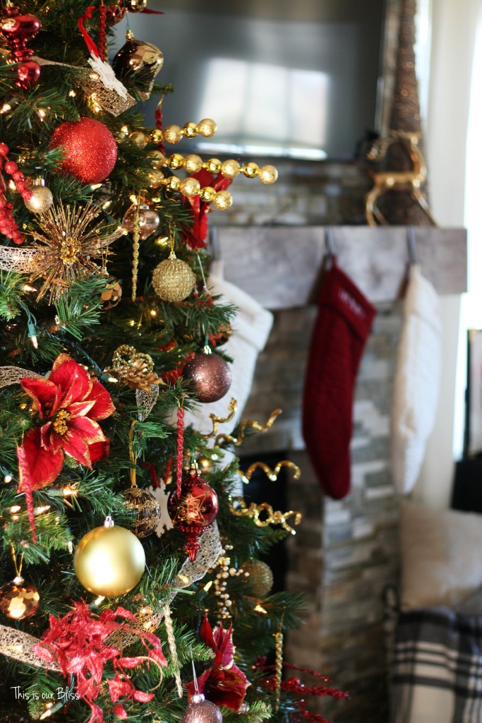 merry bright and blissful holiday home - family room christmas tree - stockings on mantle - red and gold - thisisourbliss.com