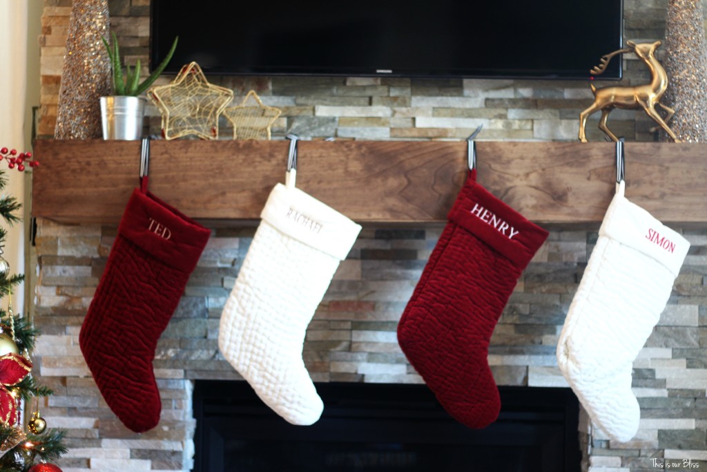 merry bright and blissful holiday home - family room mantle stockings - red and white - gold thisisourbliss.com