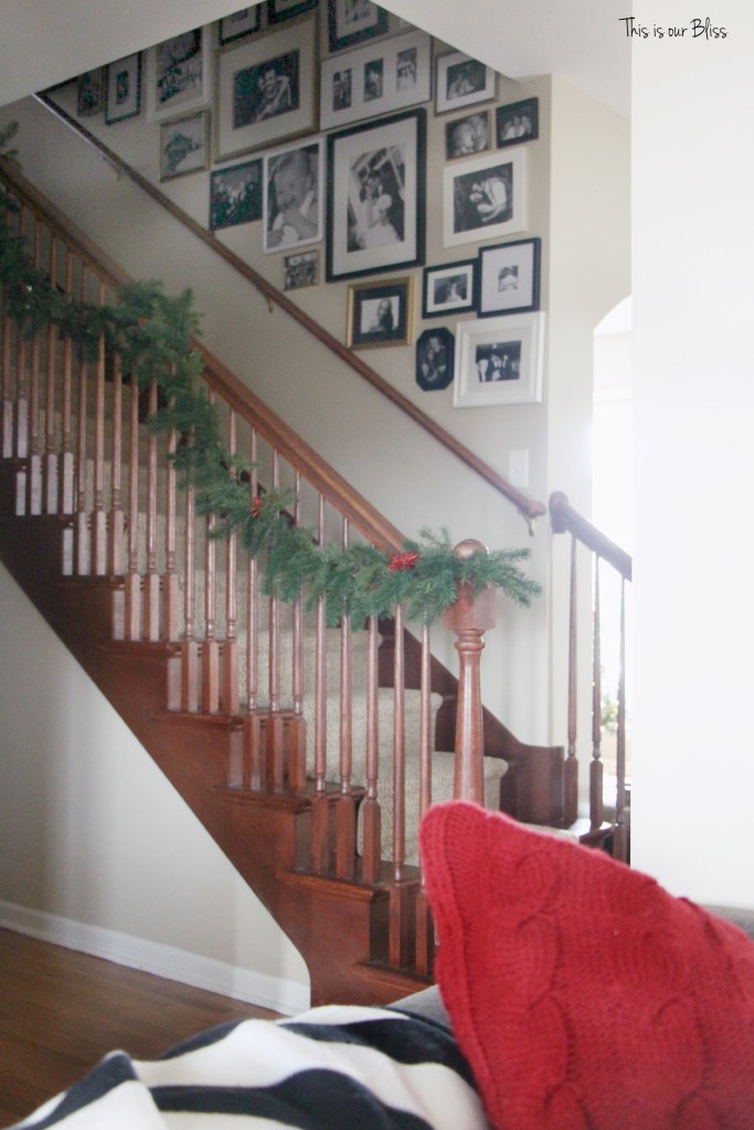 merry bright and blissful holiday home - stairwell gallery wall - staircase garland - thisisourbliss.com