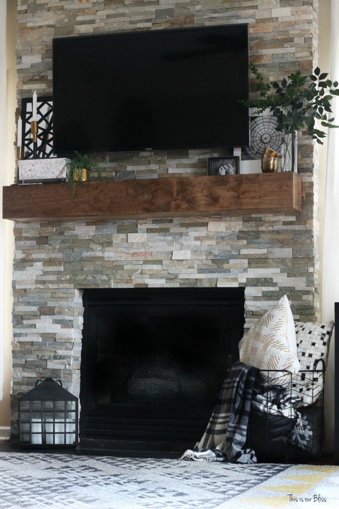 How to style a mantle - black white and gold display on rustic floating mantle - stacked stone This is our Bliss www.thisisourbliss.com