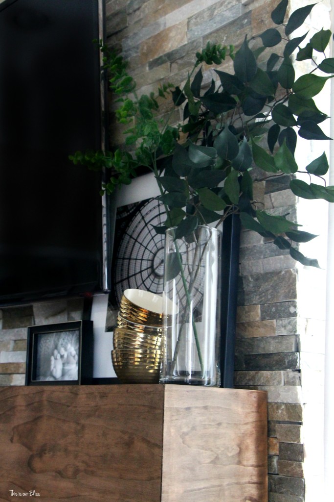 How to style a mantle table top styling hop family room mantle styling layering and leaning with faux stems black white and gold mantle This is our Bliss www.thisisourbliss.com