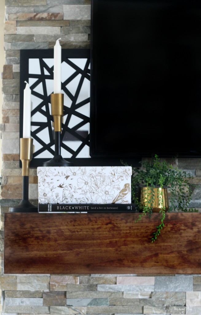 How to style a mantle table top styling hop family room mantle styling stacked books and box black white and gold mantle This is our Bliss www.thisisourbliss.com