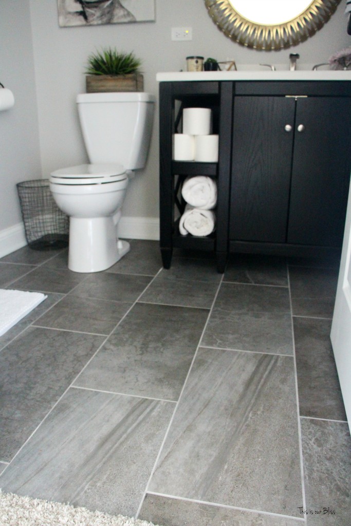 Basement bathroom reveal | gray porcelain tile floor | black vanity | neutral bathroom decor || This is our Bliss