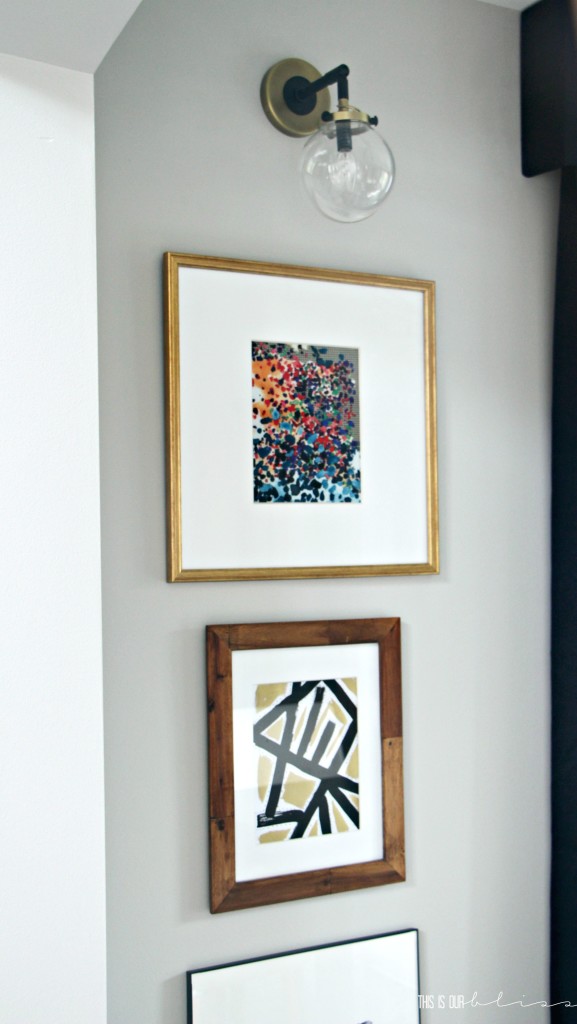 stacked-frames-under-sconces-dining-room-art-display-this-is-our-bliss