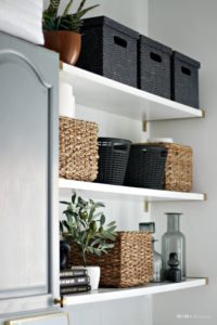 An organized and chic, Small Laundry Room makeover - updated appliances plus floating shelves with storage baskets and bins - This is our Bliss