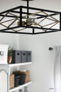 an organized and chic, small laundry Room update - black and gold semi-flush mount light in laundry room - This is our Bliss