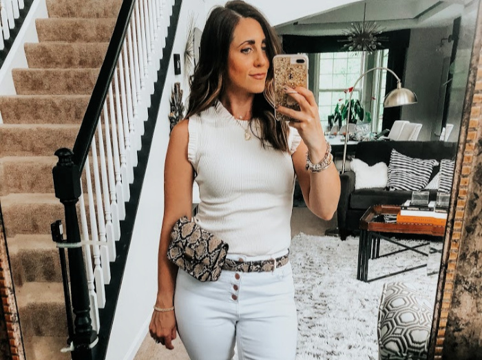 white on white outfit with snakeskin belt bag